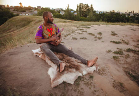 young man sitting with ukuleleの写真素材