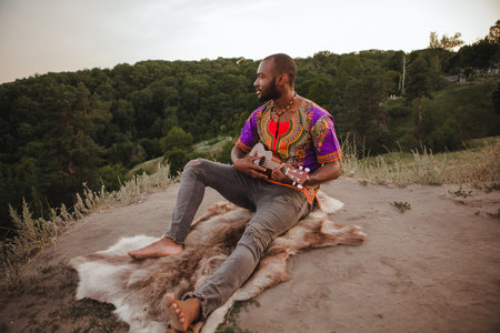 young man sitting with ukuleleの写真素材