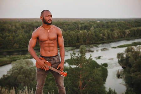 young african american sports man with ukuleleの写真素材