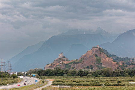 Sion, Valais, Switzerland - incoming storm over Tourbillon Castle/ChÃ¢teau de Tourbillon and ValÃ¨re Basilica/Basilique de ValÃ¨re in RhÃ´ne valleyの写真素材