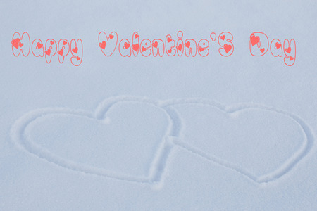 two gorgeous heart on the white snow with the words : Happy Valentine's Dayの写真素材