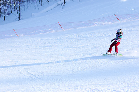 Girl snowboard riding on the track.の写真素材