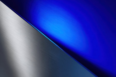 A smooth metallic surface intersects with vibrant blue light, creating an eye-catching design. The blend of textures and colors highlights modern aesthetics and artistry.の素材