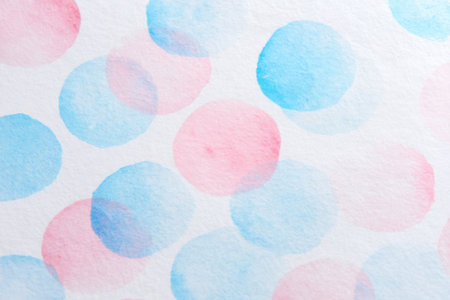 Light pink and blue circles overlap on a soft white background, creating a gentle, artistic pattern. This design can enhance a variety of creative projects and invitations.の素材