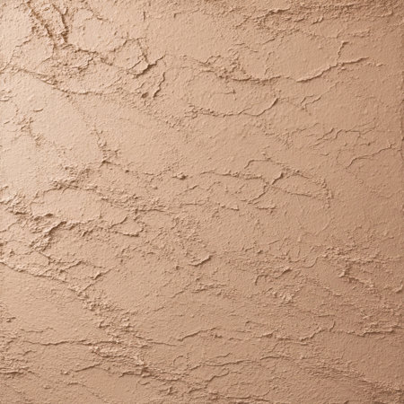 A smooth, textured wall surface in warm beige tones enhances the ambiance of the room, perfect for creating a cozy and inviting atmosphere.の素材