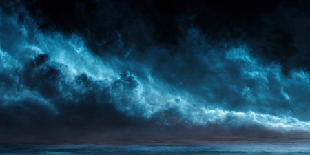 Dark clouds swirl dramatically in the sky at dusk, highlighted by blue light over the calm ocean waters, creating a moody and serene atmosphere in the fading light.の素材