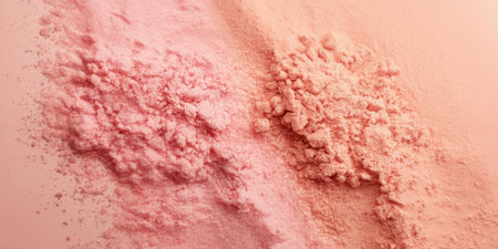 Two distinct piles of pink powder are carefully arranged on a smooth surface, showing different textures and shades. The soft colors create a pleasing aesthetic.の素材