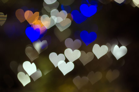White, blue and orange hearts bokeh blur lights.
