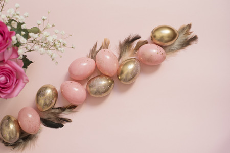 Pink and Gold Easter Eggs. Pastel Easter Concept with Eggs, Flowers and Feathers. Punchy Pastelsの写真素材
