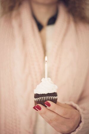 Beautiful young woman holding a birthday capcake.の写真素材