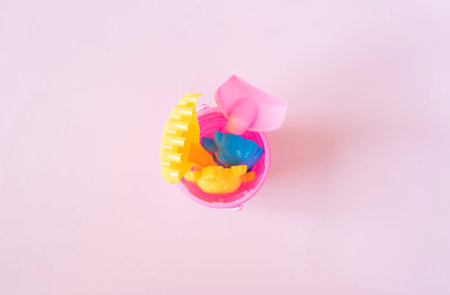 Children beach toys on pastel pink background. Summer concept. Flat lay, top view, copy space. Kids...