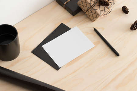 White card mockup with christmas decoration on a wooden table.の写真素材