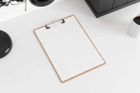 Wooden clipboard mockup wtih workspace accessories on a white table.の写真素材
