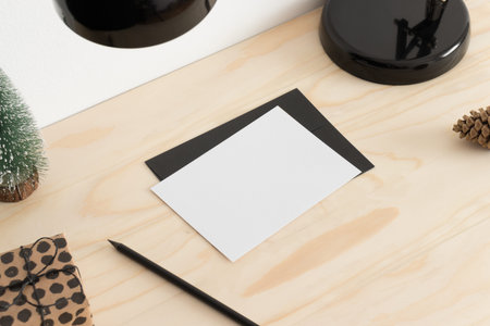 White card mockup with christmas decoration on a wooden table.
