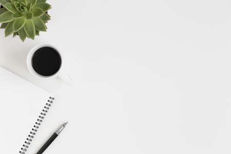 Workspace accessories, coffee and a succulent plant on a white table.  Flat lay with blank copy space.の写真素材