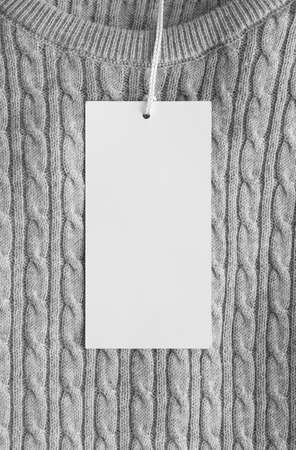 White clothing tag mockup on a grey sweater.の写真素材
