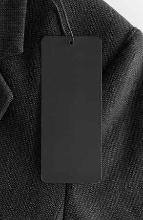 Black tag mockup on a black suit.の写真素材