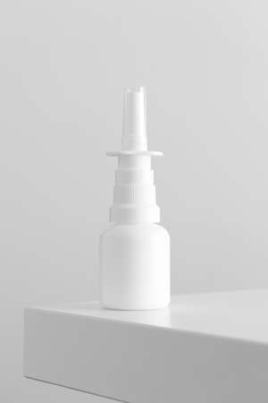 White nose spray bottle mockup on a white table.の写真素材