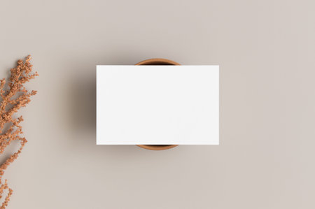White business card mockup 85x55mm with a dry flower.