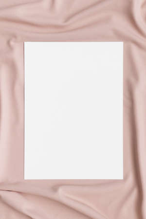 Invitation white card mockup on a beige textile. 5x7 ratio, similar to A6, A5.の写真素材