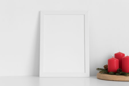 White frame mockup with candles. Christmas decoration