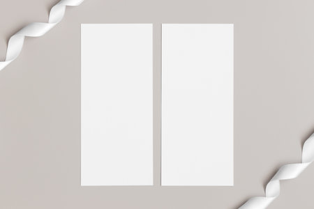Two menu cards mockup with a satin tape deocoration, 4x9 ratio.の写真素材