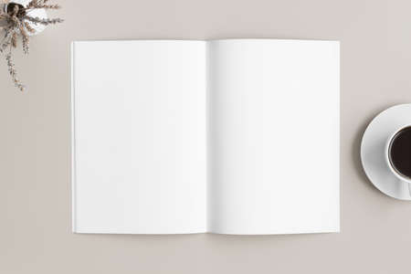 Open magazine mockup with a cup of coffee and a lavender on the beige table.の写真素材