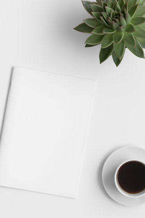 Magazine mockup with a cup of coffee and a echeveria plant on the white table.の写真素材