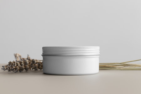 White cosmetic cream jar mockup with a lavender on the beige table.の写真素材