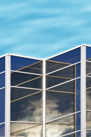 cloud reflections in office building window glass