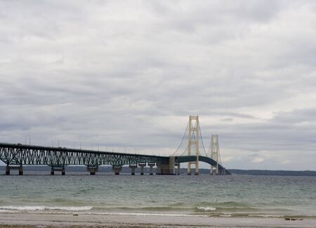 Mackinaw (Mackinac)  bridge on a cloudy day in northern Michigan it's an suspension bridge.  The Mackinaw bridge connects the upper peninsula to the lower peninsula.  The bridge was Open to traffic November 1, 1957.  The Mackinac bridge is also know as thの写真素材