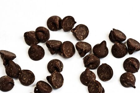 tasty chocolate chips on a white backgroundの写真素材