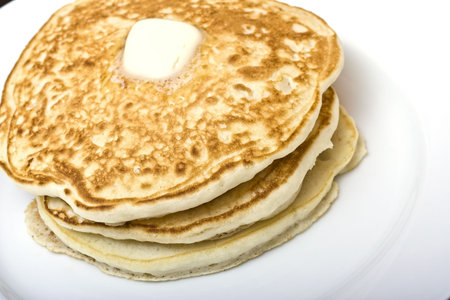 stack of buttermilk pancakes on a white plate