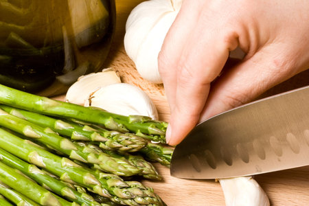 fresh asparagus and garlic on a cutting board healthyの写真素材