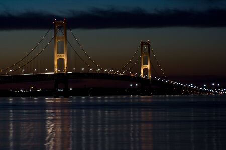 mackinaw bridge at night great colors cloudy skyの写真素材