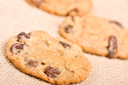 oatmeal raisin cookies on a burlap background macro fresh out of the oven