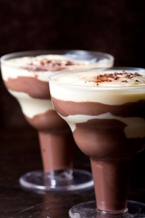 chocolate and vanilla pudding in a parfait glass dusting of chocolate on topの写真素材