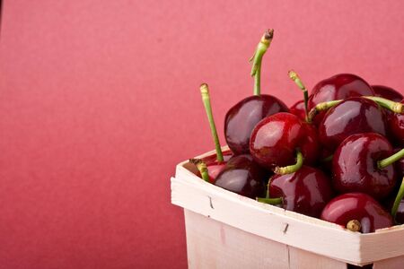 quart of ripe cherries in a wood containerの写真素材