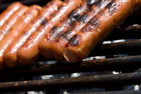 hotdogs on the grill outdoor on a small grillの写真素材