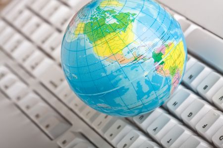 concept of the world wide web globe on a computer keyboardの写真素材