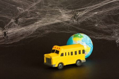 concept of slow learning school bus and cobwebs on blackの写真素材
