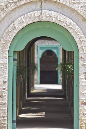 a arched brick doorway leading back to a another doorway 