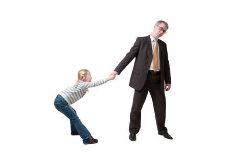 daughter pulls father for handの写真素材