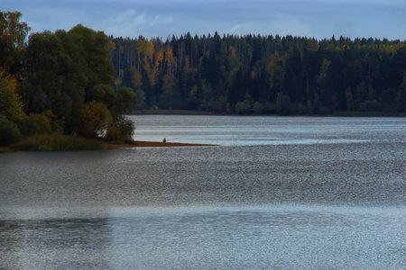 fisherman in lake in autumnの写真素材