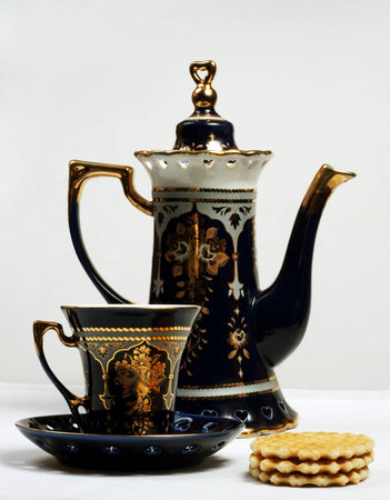 teapot, teacup and cookies on table