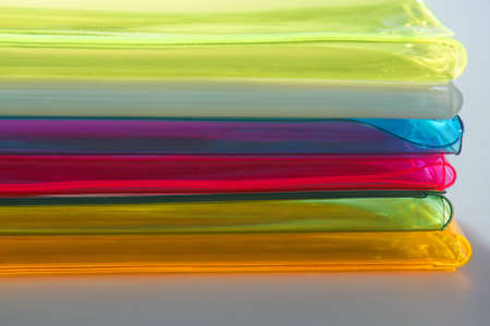 The colour plastic covers, lying a pileの写真素材