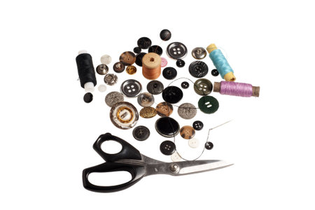  scissors,  lot of buttons and threads on a white background