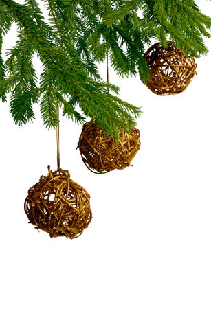 three golden christmas toys, which hang on fir tree の写真素材