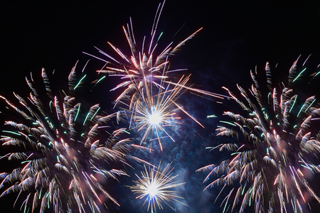 Brightly colorful fireworks and salute of various colors in the night skyの写真素材