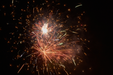 Brightly colorful fireworks and salute of various colors in the night skyの写真素材
